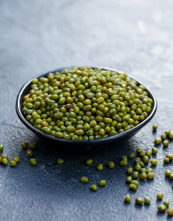 Mung Bean, Green Moong Dal in Wooden Bowl. Copy Space. Grey Slate Background.